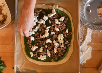 The Locavore Pizza – with Sausage, Goat Cheese, & Spinach Pesto