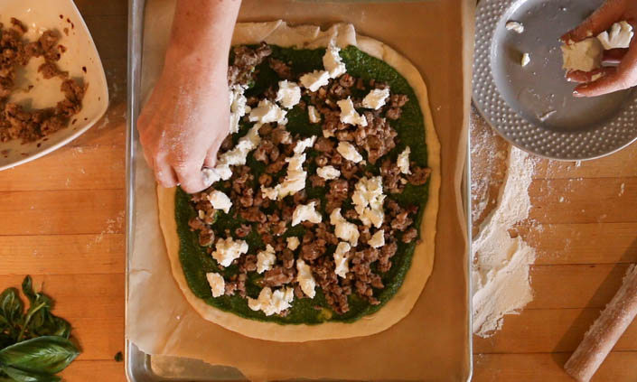 The Locavore Pizza – with Sausage, Goat Cheese, & Spinach Pesto